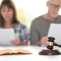 Couple going through divorce in courtroom Couple going through divorce in courtroom