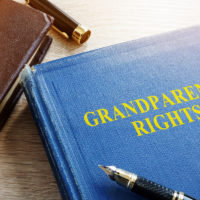 Book that reads Grandparents Rights addressing elder law with glasses on table