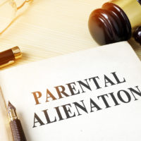 Book about parental alienation on a table next to gavel Book about parental alienation on a table next to gavel