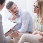 couple talking with mediator in mediation session