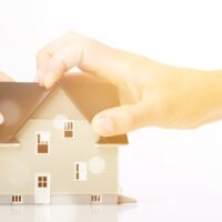 Hand and model house divorce house separation real estate human Hand and model house divorce house separation real estate human