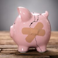 Broken Pink Piggybank With Bandage Broken Pink Piggybank With Bandage