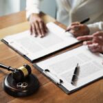 Judge gavel with pair of marriage ring, Divorce concept.