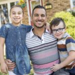 Portrait of happy family in front  house