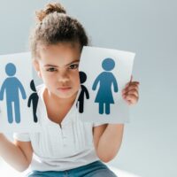 african american child holding ripped paper with family on white