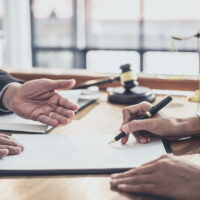 Male lawyer or judge consult having team meeting with Businesswoman client, Law and Legal services concept. Male lawyer or judge consult having team meeting with Businesswoman client, Law and Legal services concept.